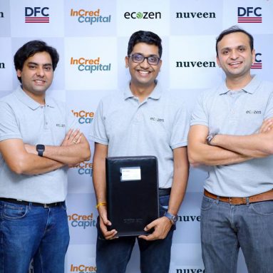 Three directors of ecozen posing in front of a checkered logo board with logos of nuvee, DFC & Incred Capital