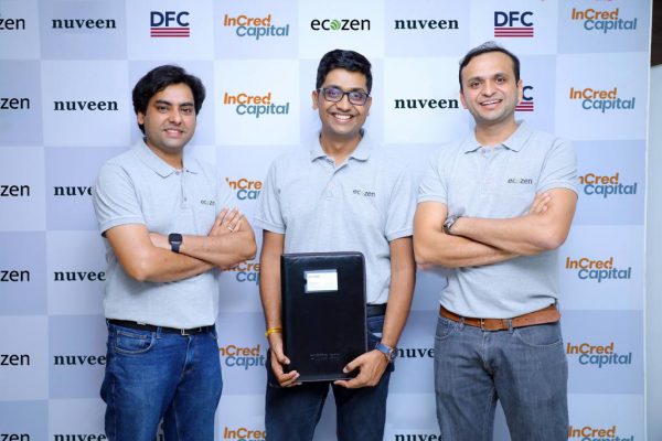 Three directors of ecozen posing in front of a checkered logo board with logos of nuvee, DFC & Incred Capital